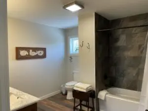 A washroom with white towels and a painting